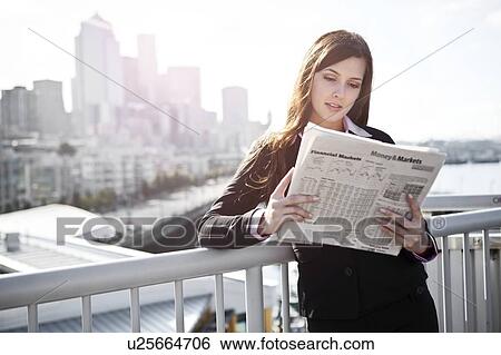USA, Seattle, Young businesswoman reading newspaper View Large Photo Image Stock Photograph - USA, Seattle, Young businesswoman reading newspaper. Fotosearch