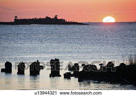 Stock Image - USA, South Carolina, Charleston, Castle Pinckney at sunrise. Fotosearch