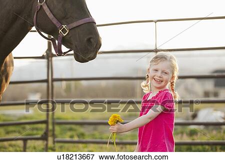 USA, Utah, Lehi, Portrait of girl (2-3) standing with horse View Large Photo Image Stock Photo - USA, Utah, Lehi, Portrait of girl (2-3) standing with horse. Fotosearch