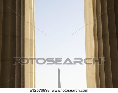 Stock Photo - USA, Washington DC, Washington Monument between columns. Fotosearch