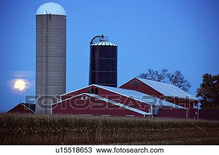Stock Image - USA, Wisconsin, Moonrise over farm. Fotosearch
