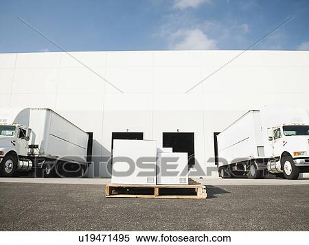 Warehouse with trucks and load View Large Photo Image Stock Photography - Warehouse with trucks and load. Fotosearch