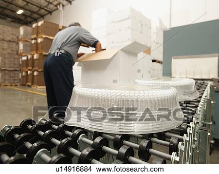 Warehouse worker assembling merchandise View Large Photo Image Picture - Warehouse worker assembling merchandise. Fotosearch