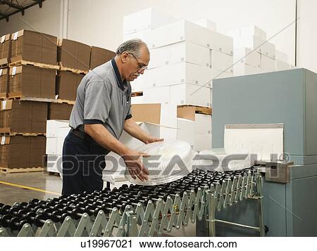 Warehouse worker assembling merchandise View Large Photo Image Stock Image - Warehouse worker assembling merchandise. Fotosearch