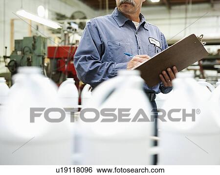 Warehouse worker checking merchandise View Large Photo Image Stock Photograph - Warehouse worker checking merchandise. Fotosearch