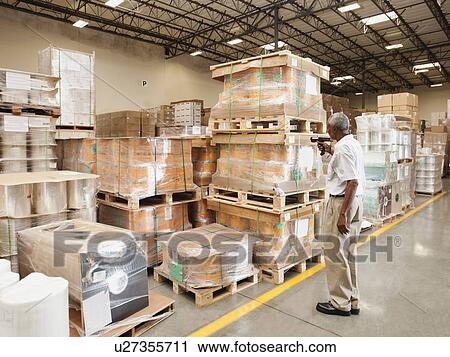 Warehouse worker scanning delivery View Large Photo Image Stock Image - Warehouse worker scanning delivery. Fotosearch