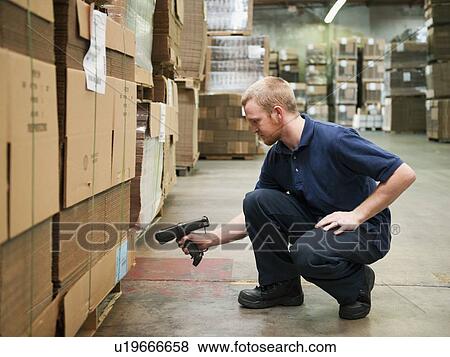 Stock Photo - Warehouse worker scanning delivery. Fotosearch