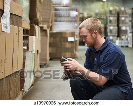 Stock Photograph - Warehouse worker scanning delivery. Fotosearch