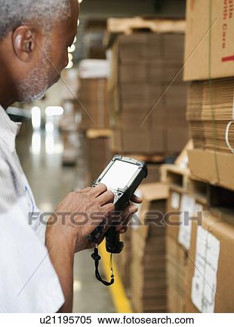 Stock Photography - Warehouse worker scanning delivery. Fotosearch