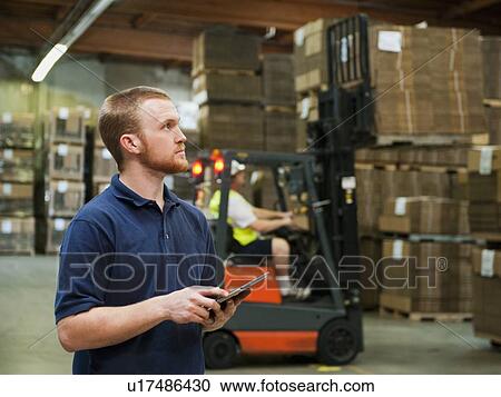Stock Image - Warehouse worker. Fotosearch