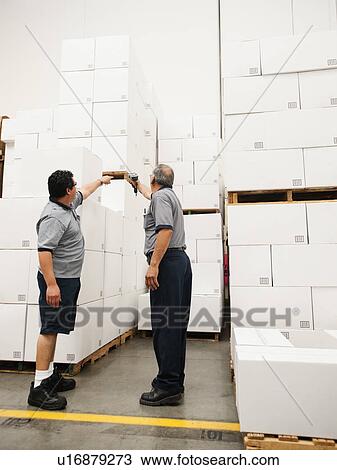 Stock Image - Warehouse workers scanning delivery. Fotosearch