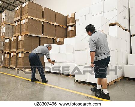 Stock Photograph - Warehouse workers scanning delivery. Fotosearch