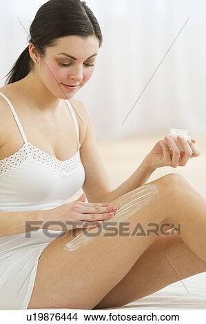 Woman applying moisturizer View Large Photo Image Picture - Woman applying moisturizer. Fotosearch