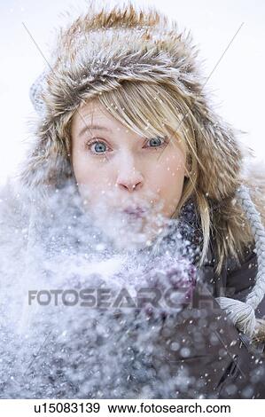 Stock Photo - Woman blowing snow. Fotosearch