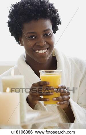 Stock Photograph - Woman drinking juice in spa. Fotosearch