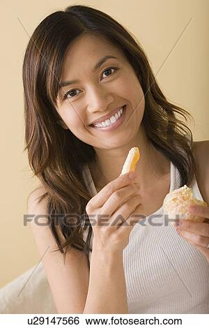 Woman eating orange View Large Photo Image Stock Photograph - Woman eating orange. Fotosearch