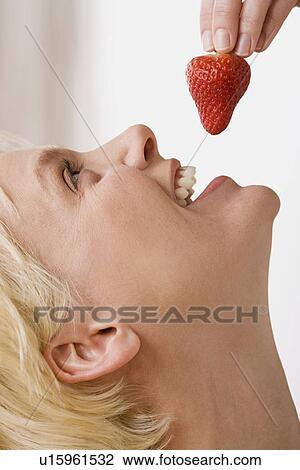 Woman eating strawberry View Large Photo Image Stock Image - Woman eating strawberry. Fotosearch