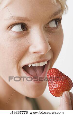Woman eating strawberry View Large Photo Image Stock Photograph - Woman eating strawberry. Fotosearch
