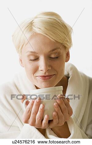 Stock Photograph - Woman enjoying hot drink. Fotosearch