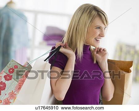 Woman holding shopping bags View Large Photo Image Stock Image - Woman holding shopping bags. Fotosearch