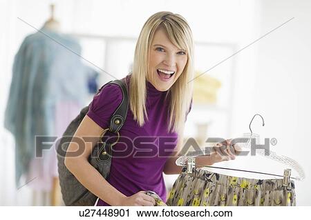 Woman in clothes store View Large Photo Image Stock Image - Woman in clothes store. Fotosearch