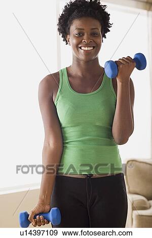 Woman lifting dumbbells View Large Photo Image Stock Photo - Woman lifting dumbbells. Fotosearch