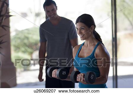 Woman lifting weights View Large Photo Image Stock Photo - Woman lifting weights. Fotosearch