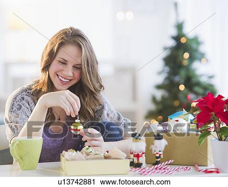 Woman looking at christmas decoration View Large Photo Image Stock Image - Woman looking at christmas decoration . Fotosearch