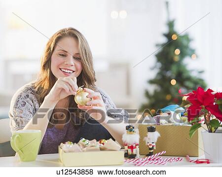 Woman looking at christmas decoration View Large Photo Image Stock Photo - Woman looking at christmas decoration . Fotosearch