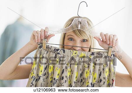 Woman looking at skirt in clothes store View Large Photo Image Stock Image - Woman looking at skirt in clothes store. Fotosearch
