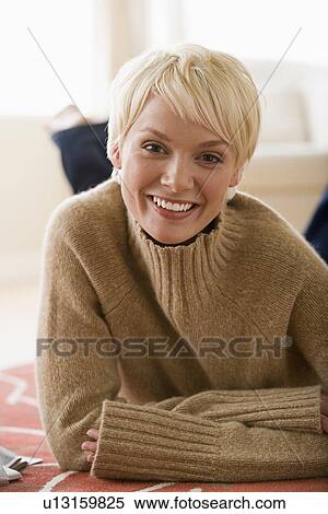 Stock Photography - Woman lying on floor. Fotosearch