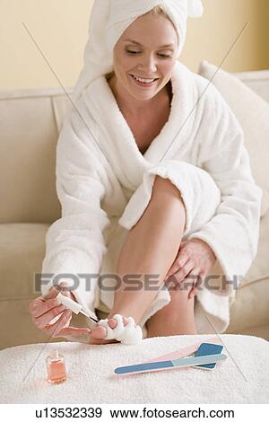 Woman painting toenails View Large Photo Image Stock Photo - Woman painting toenails. Fotosearch