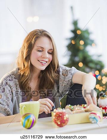 Stock Photo - Woman preparing christmas decoration . Fotosearch