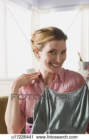 Woman presenting new dress View Large Photo Image Stock Image - Woman presenting new dress. Fotosearch