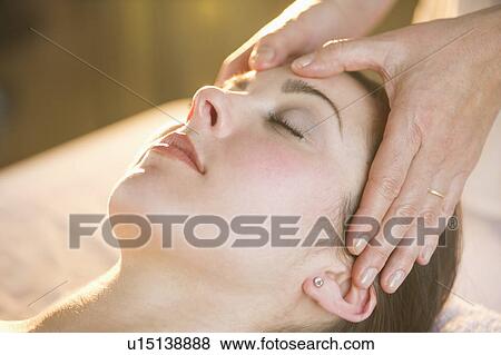 Woman receiving face massage View Large Photo Image Stock Photo - Woman receiving face massage. Fotosearch