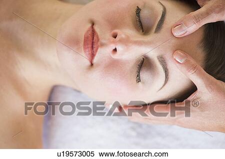 Stock Photography - Woman receiving face massage. Fotosearch