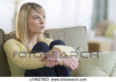 Woman sitting on sofa View Large Photo Image Stock Image - Woman sitting on sofa. Fotosearch