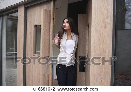 Woman standing in doorway View Large Photo Image Stock Image - Woman standing in doorway. Fotosearch