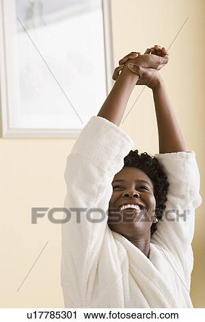 Stock Image - Woman stretching in morning. Fotosearch