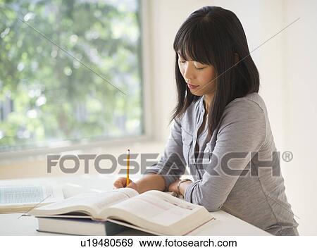 Stock Photo - Woman studying. Fotosearch