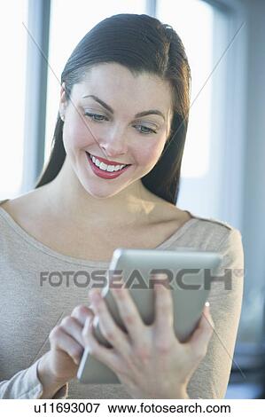 Woman using tablet pc View Large Photo Image Stock Photo - Woman using tablet pc. Fotosearch