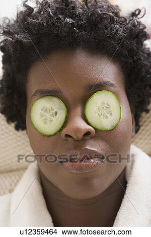 Woman with cucumber slices on eyes View Large Photo Image Picture - Woman with cucumber slices on eyes. Fotosearch