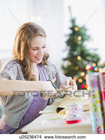 Picture - Woman wrapping christmas presents. Fotosearch
