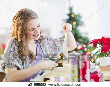 Woman wrapping christmas presents View Large Photo Image Stock Image - Woman wrapping christmas presents. Fotosearch