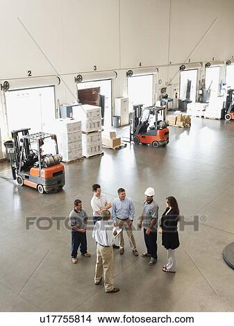 Workers talking in warehouse View Large Photo Image Picture - Workers talking in warehouse. Fotosearch