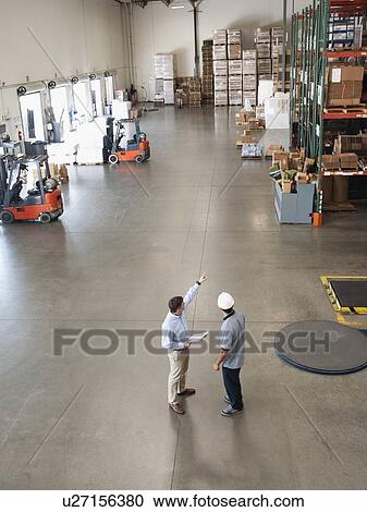 Workers talking in warehouse View Large Photo Image Stock Image - Workers talking in warehouse. Fotosearch