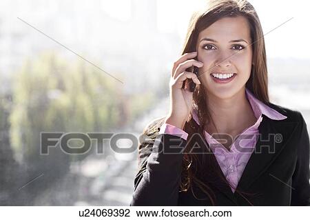 Young businesswoman talking via mobile View Large Photo Image Stock Image - Young businesswoman talking via mobile. Fotosearch