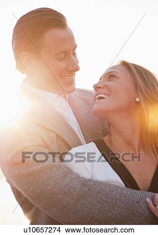 Picture - Young couple flirting outdoors. Fotosearch