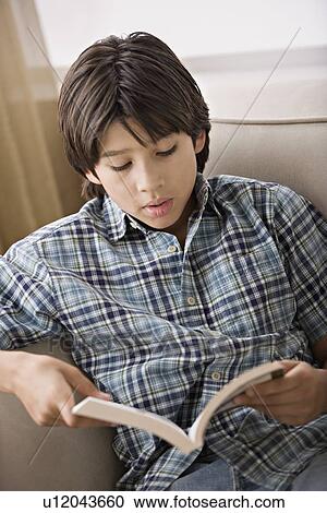 Stock Image - Young man reading book. Fotosearch