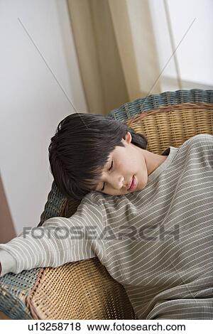 Young man sleeping on armchair View Large Photo Image Stock Photo - Young man sleeping on armchair. Fotosearch
